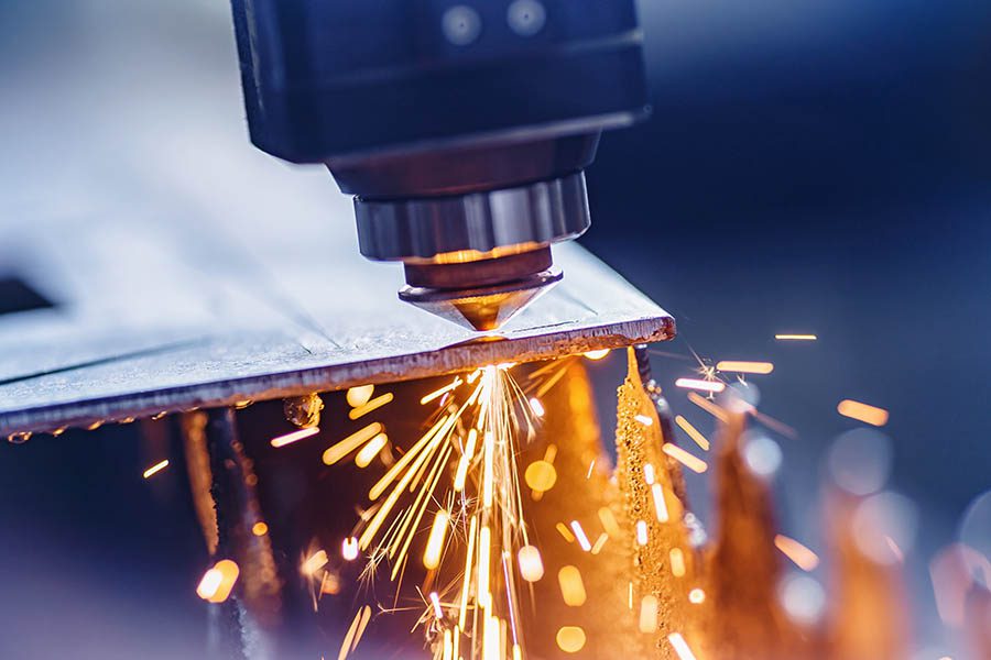 Machine Shop Insurance - Welding Metal to a New Machine with Sparks Flying